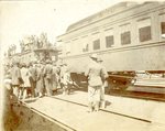Troop train at the station with men standing on top of cars (MSS 31 B3 F8 #23b)