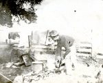 Cook cleaning up at a campfire site (MSS 31 B3 F8 #18f) by Manuscripts & Folklife Archives